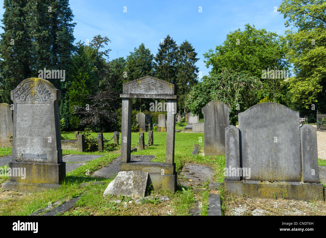 Three graves on graveyard; one stone is missing and can be looked