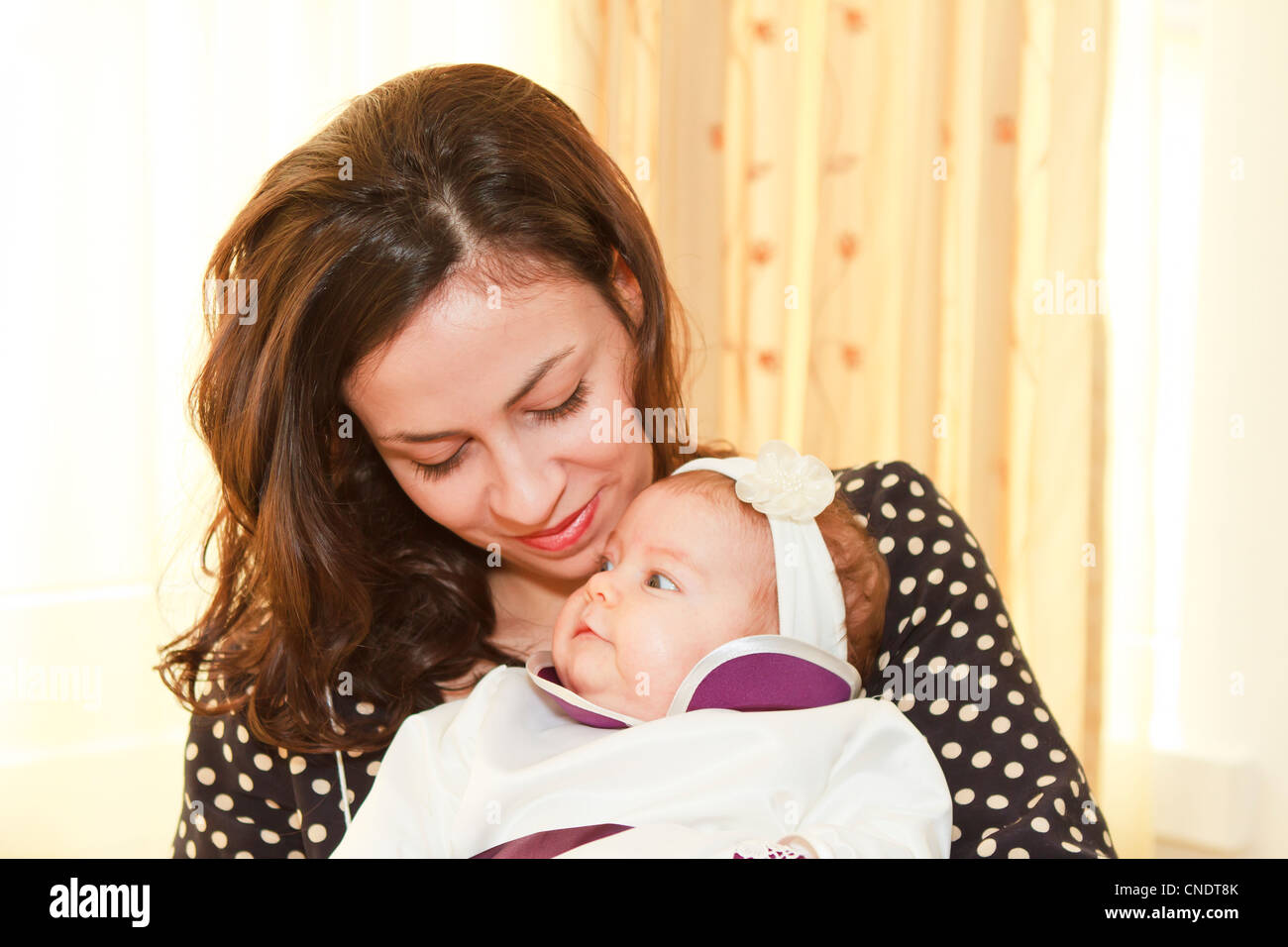 Loving moment of tenderness between a mother and her two moths old baby Stock Photo