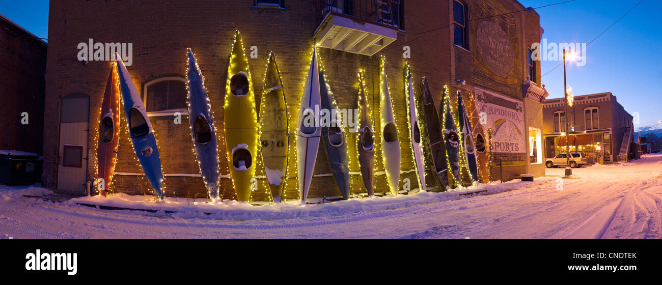 Dusk view of holiday lights illuminate colorful kayaks along a historic building in downtown Salida, Colorado, USA. Stock Photo