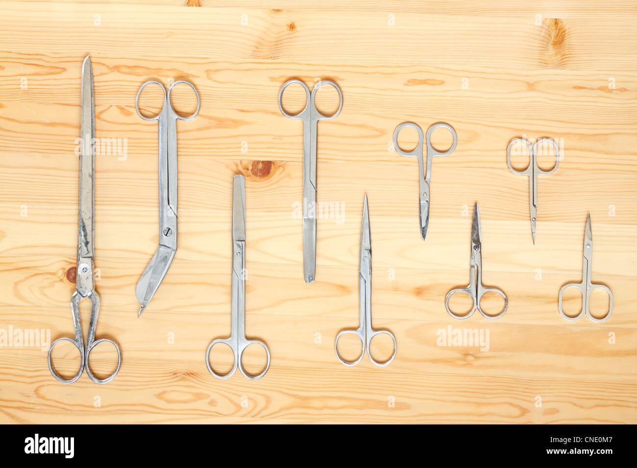 There are many different scissors lying on the boards Stock Photo - Alamy