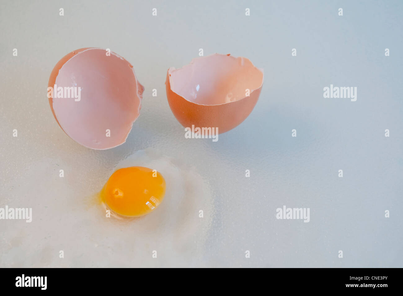 Cracked egg with a small yolk. Stock Photo