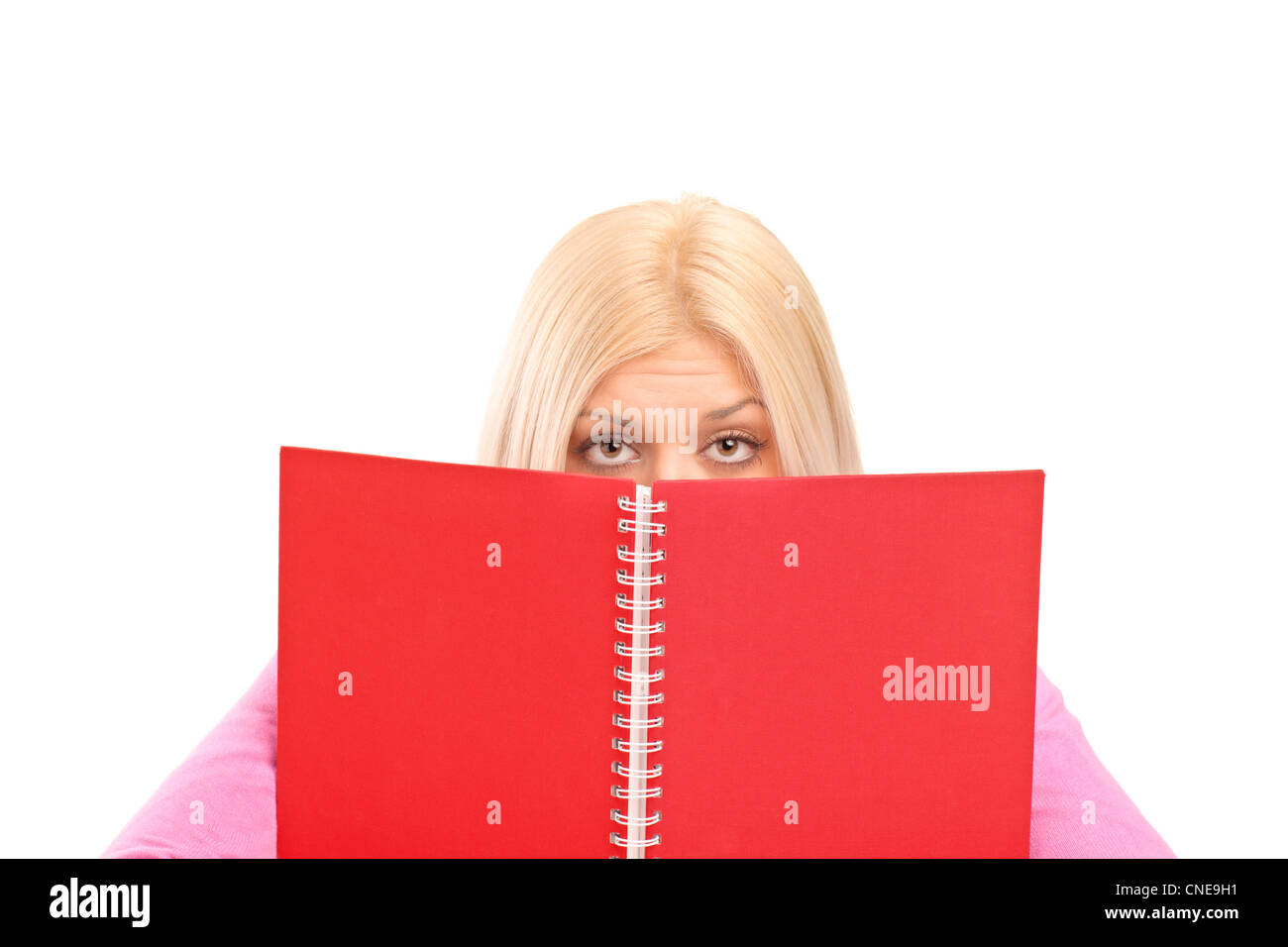 An afraid female covering behind book isolated on white background Stock Photo