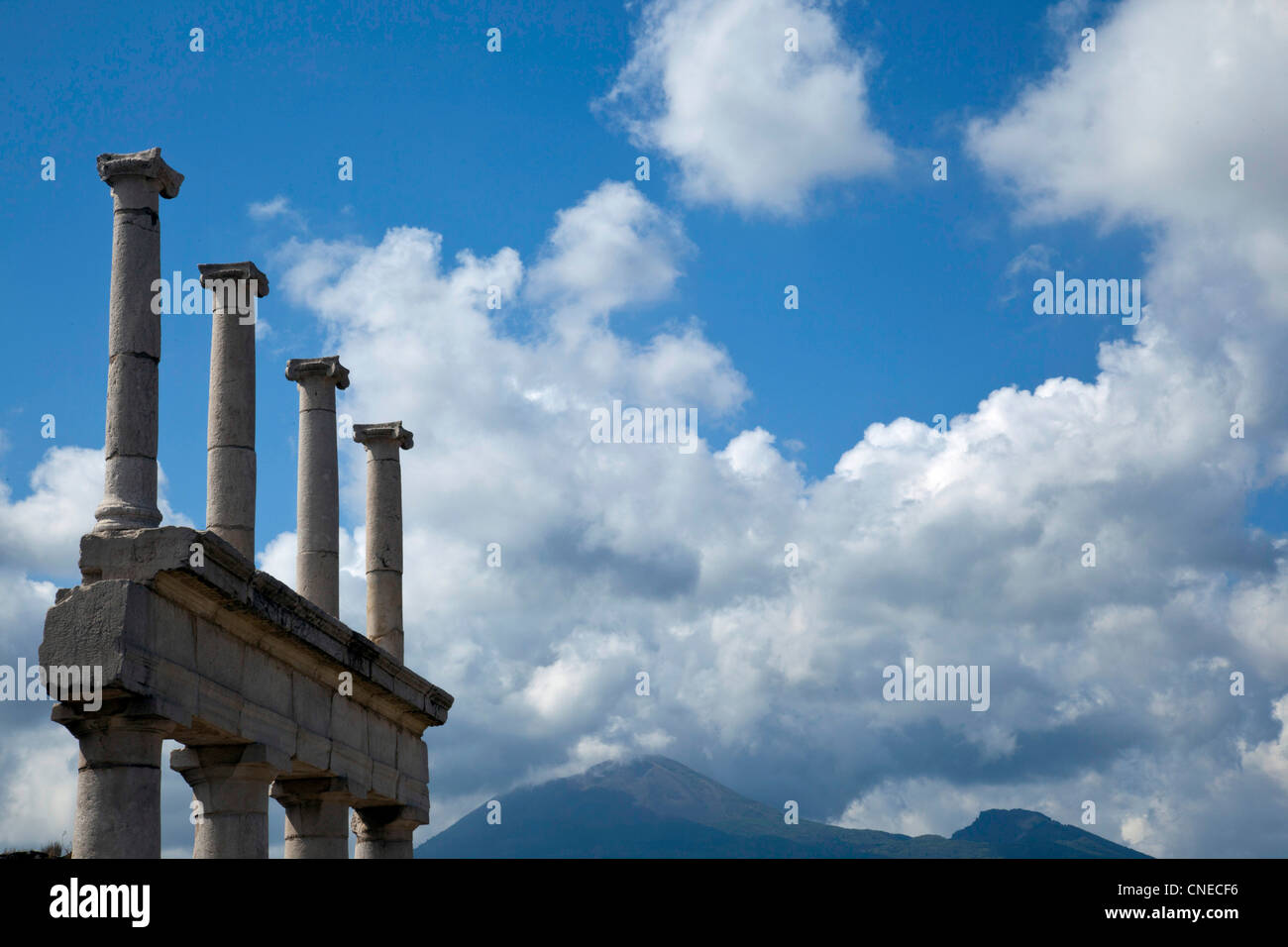 Architectural ruins of Pompeii, Italy rise-up in the shadows of Mount Vesuvius. Stock Photo