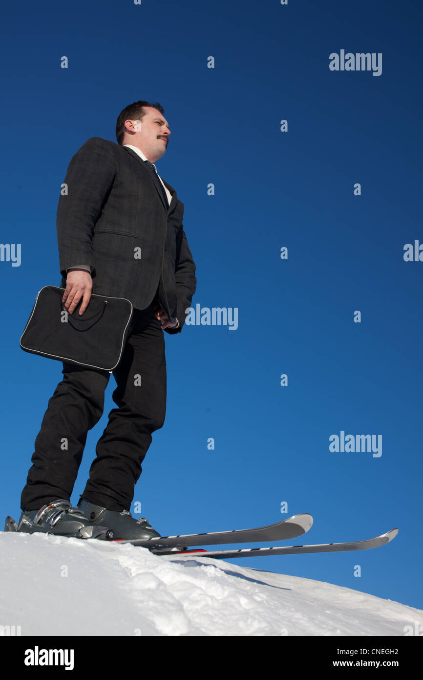 Man in busines sute on ski witn folder Stock Photo