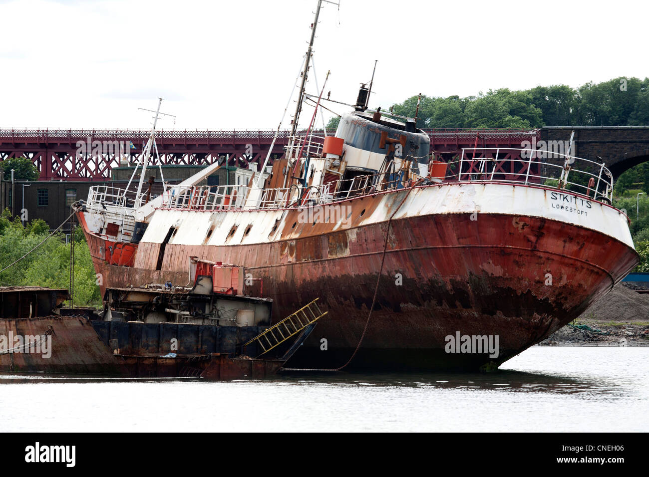 Rusting trawler in scrapyard in Scotland waiting to be scrapped Stock Photo