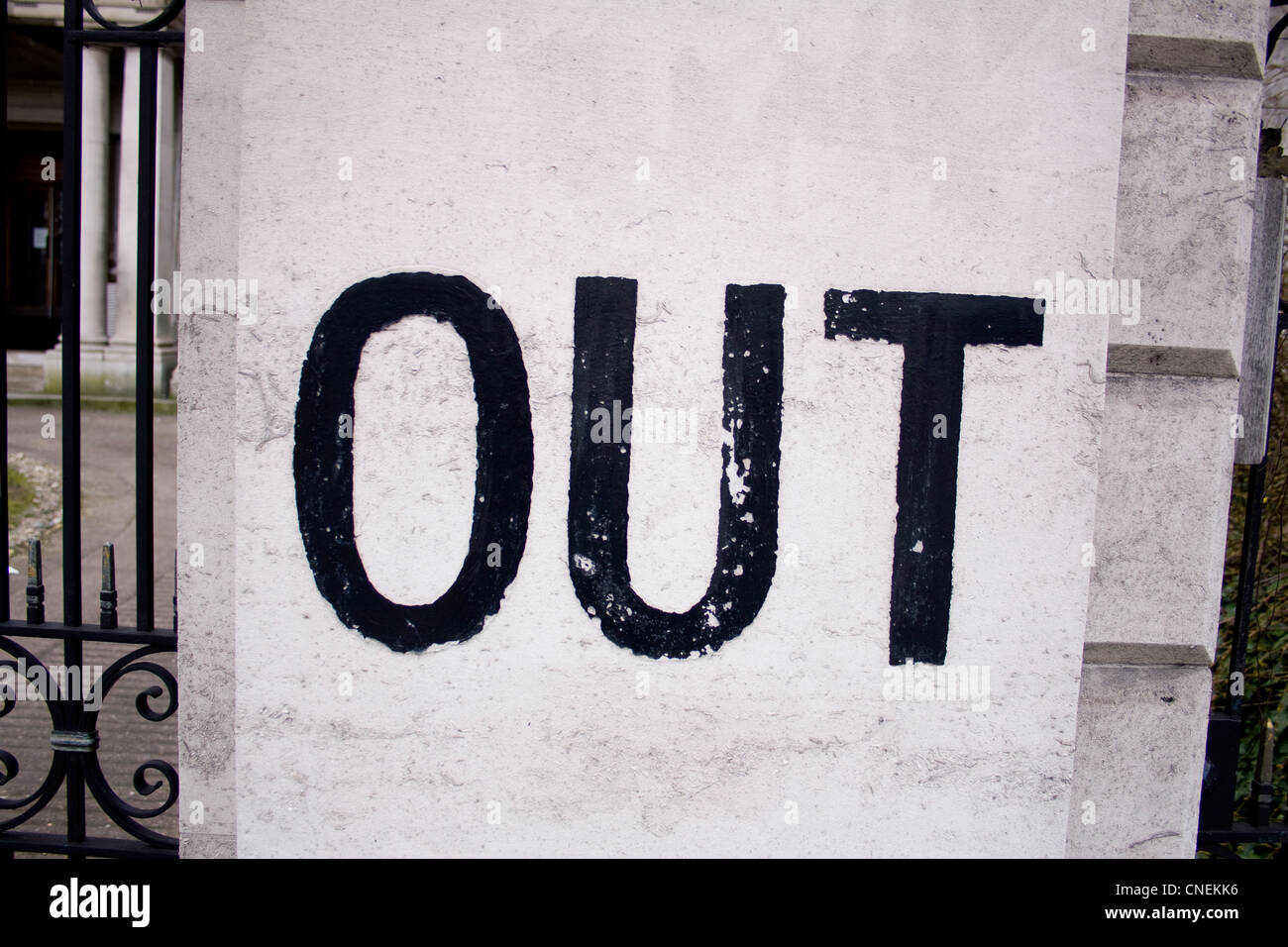 A black and white 'out' sign on a door post. Stock Photo