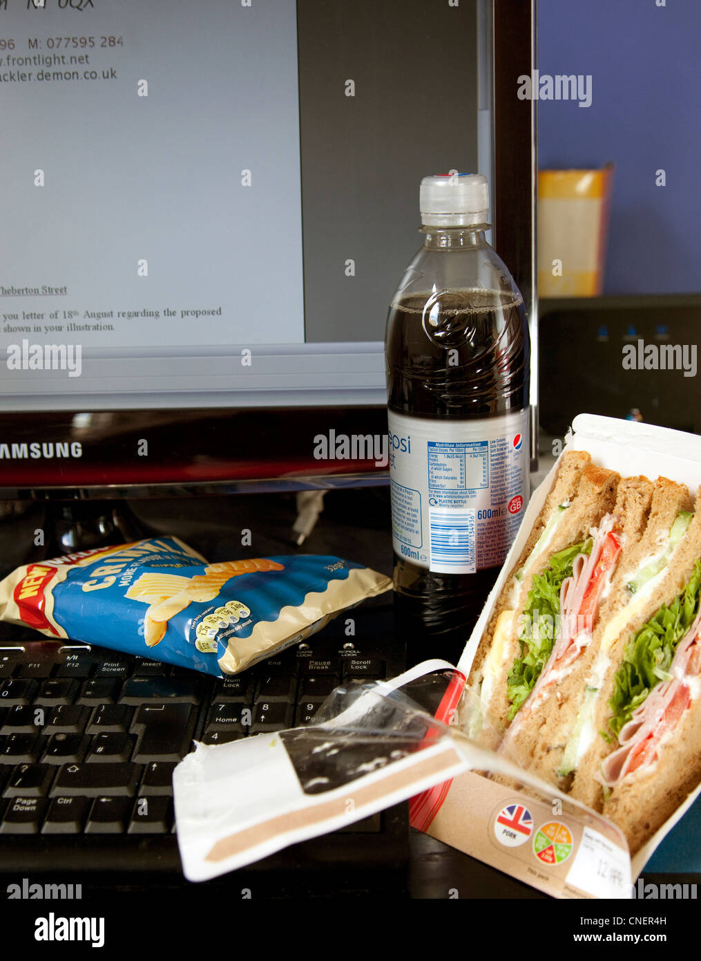 Snack lunch at office desk, London Stock Photo Alamy