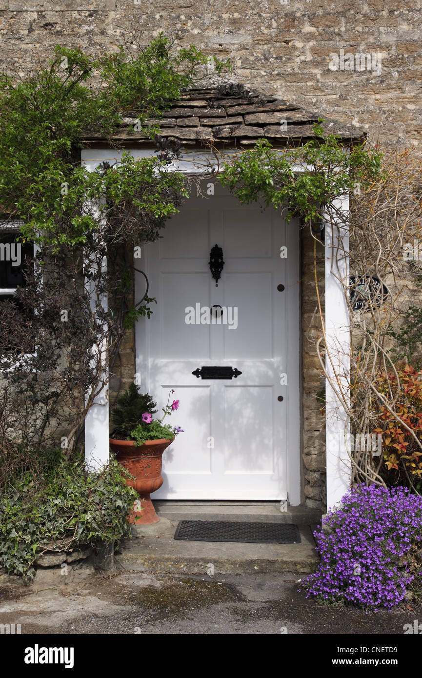 Traditional white front door on a cottage in Biddestone village, Wiltshire, England,UK Stock Photo