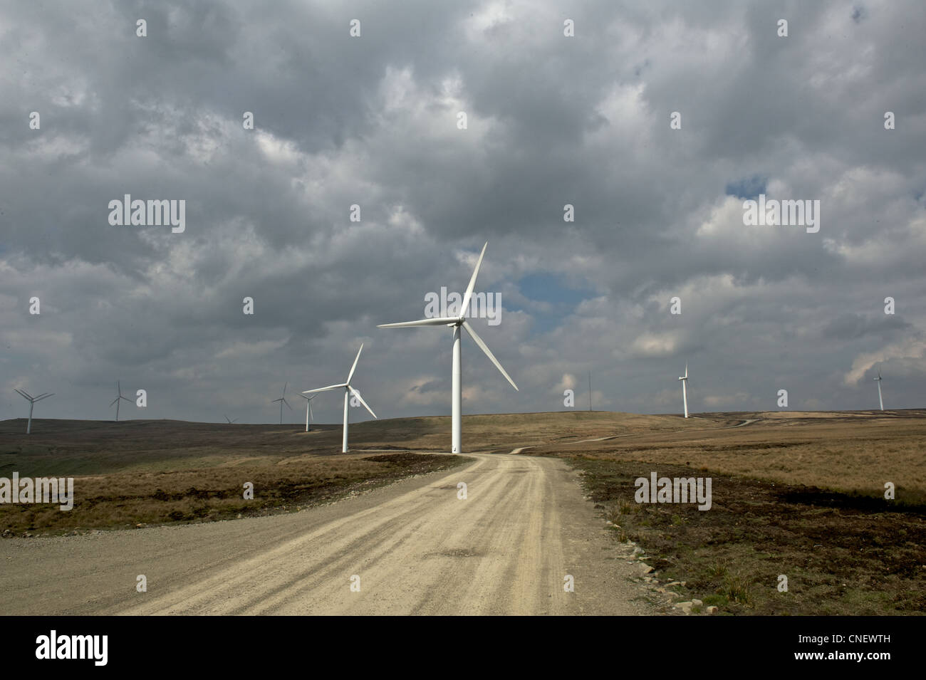 Wind turbines against a cloudy sky Stock Photo - Alamy
