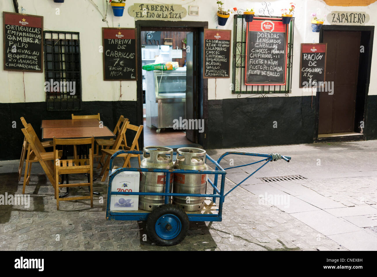 propane gas bottles on hand cart in front of bar in Cadiz, Andalusia, Spain Stock Photo