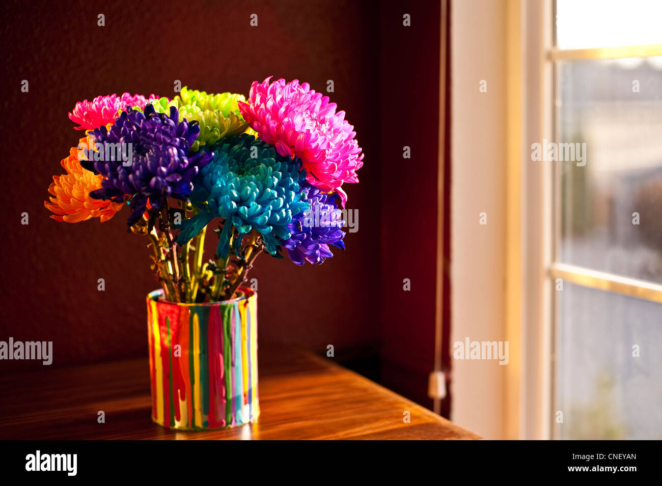 Multicolored Chrysanthemums In Paint Can On Chest Of Drawers