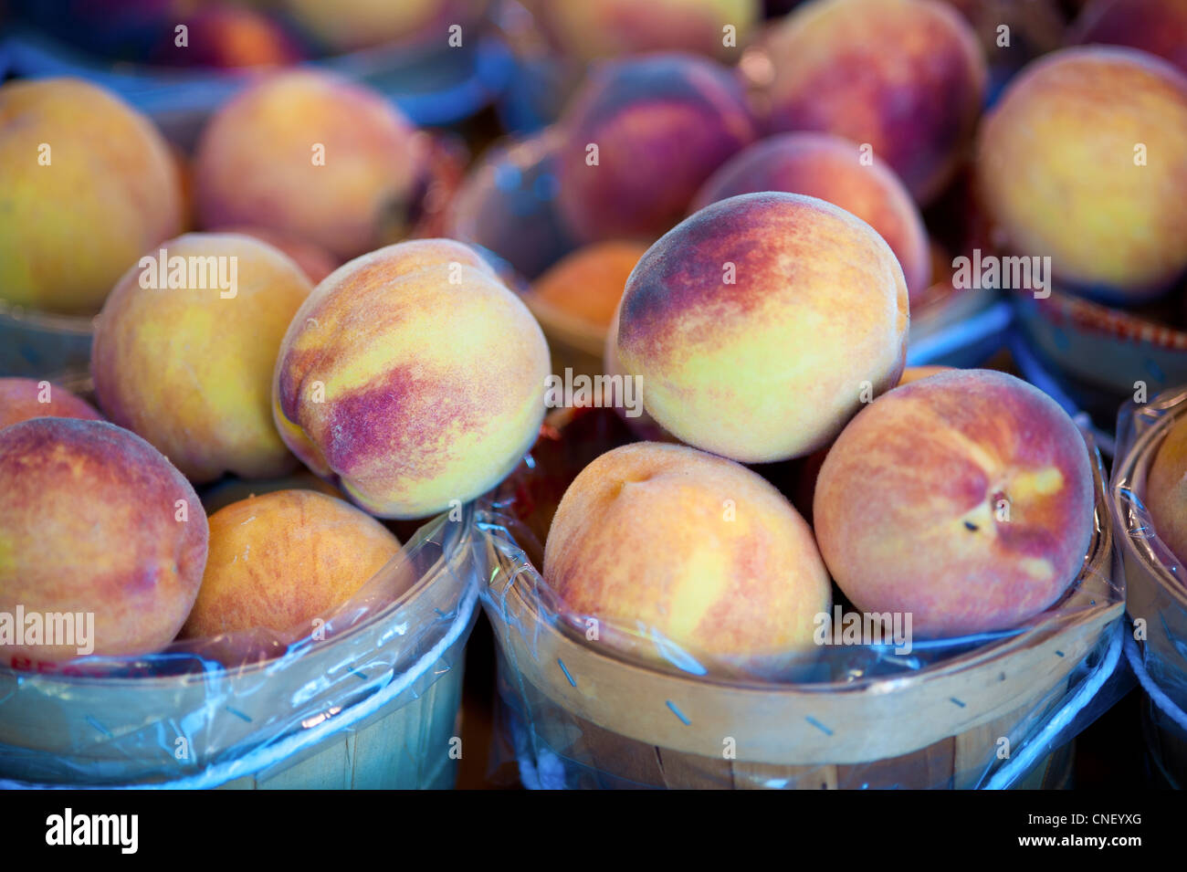 Small baskets of peaches Stock Photo