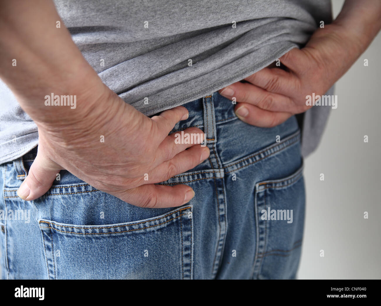 a man experiences pain in his hips Stock Photo