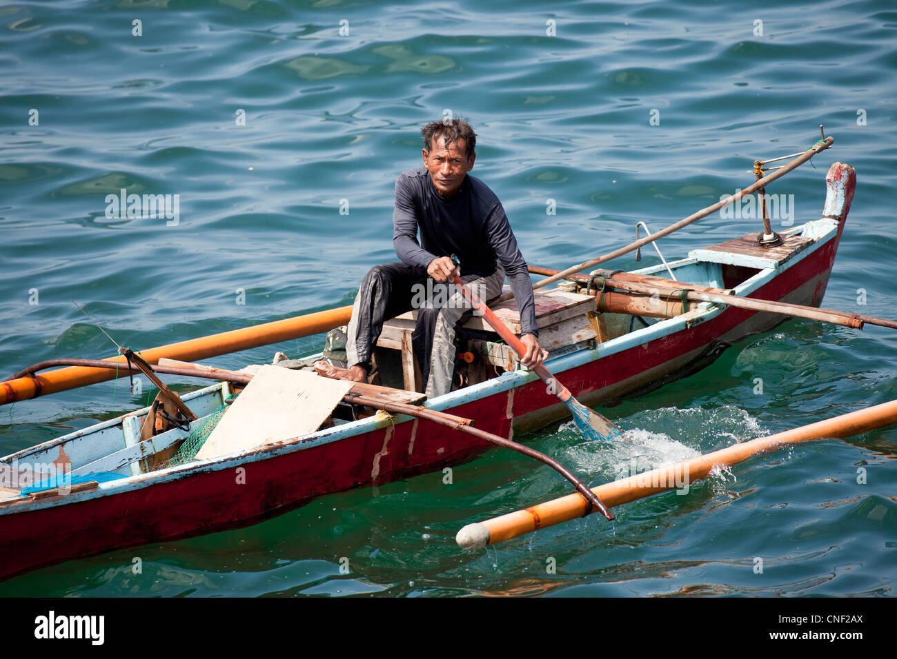 fishermen in his typical outrigger boat, Manila, Philippines, Asia Stock Photo
