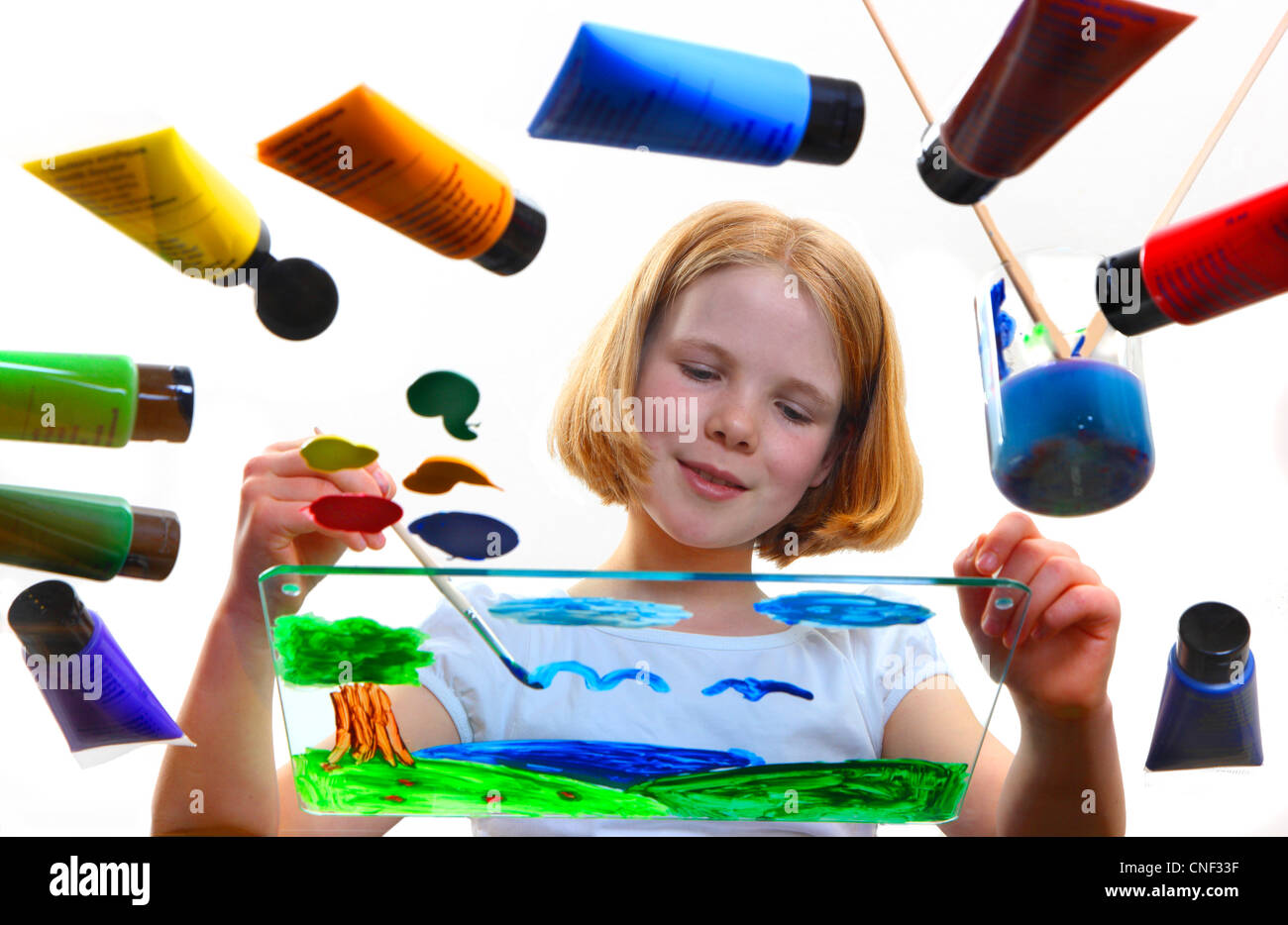 Young girl is painting a picture with Acrylic colors. Stock Photo