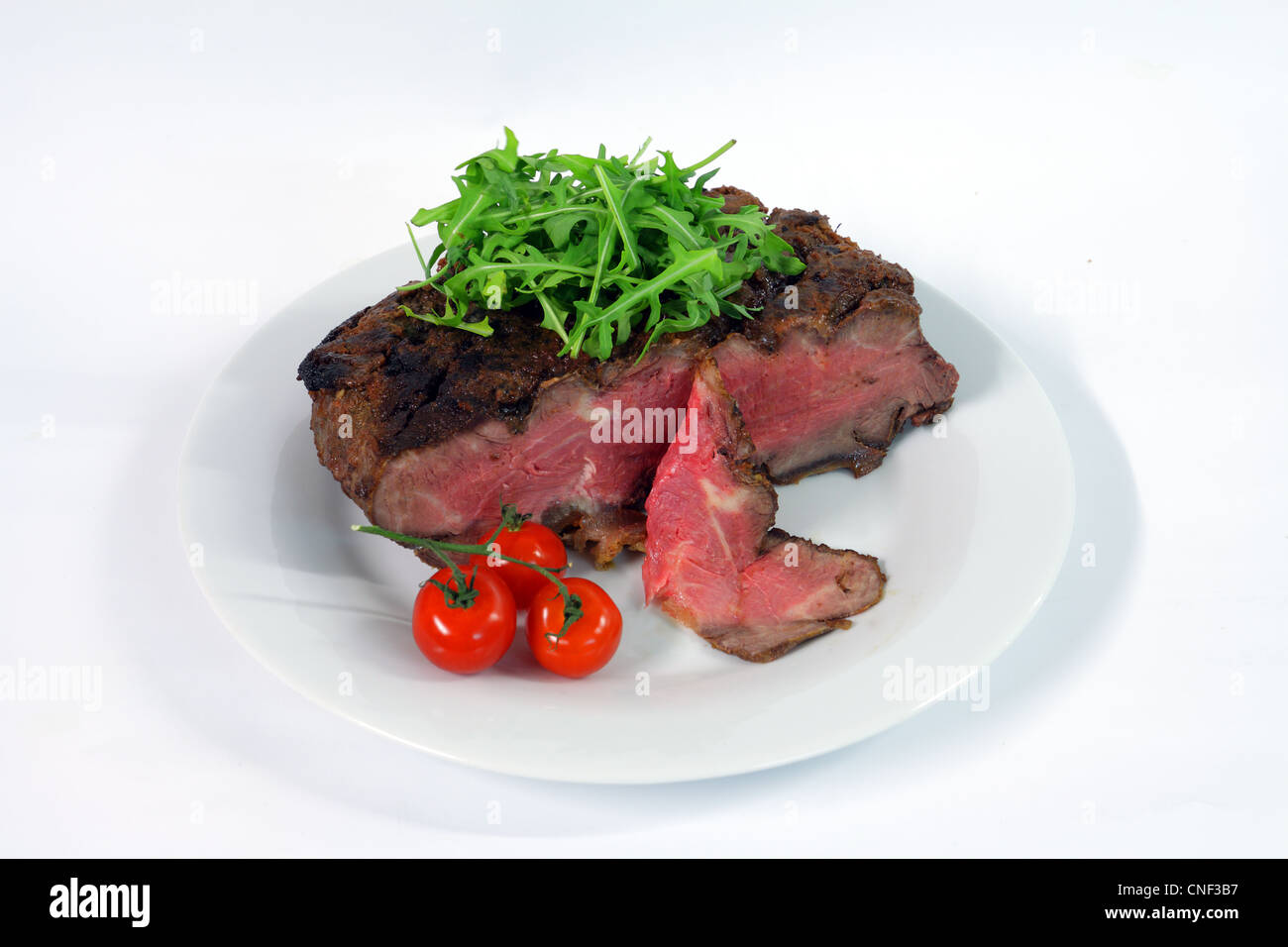 Roastbeef with gherkin and hot pepper on white background Stock Photo