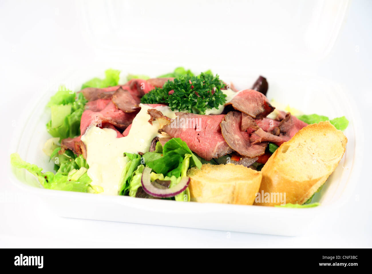 Roastbeef with fresh vegetable salad on white background Stock Photo