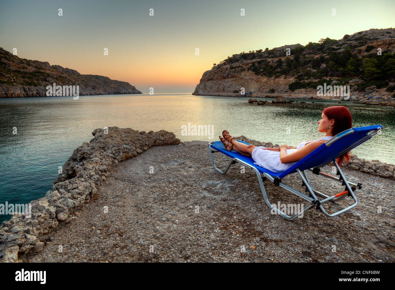 Woman watching beautiful sunset hi-res stock photography and images - Alamy
