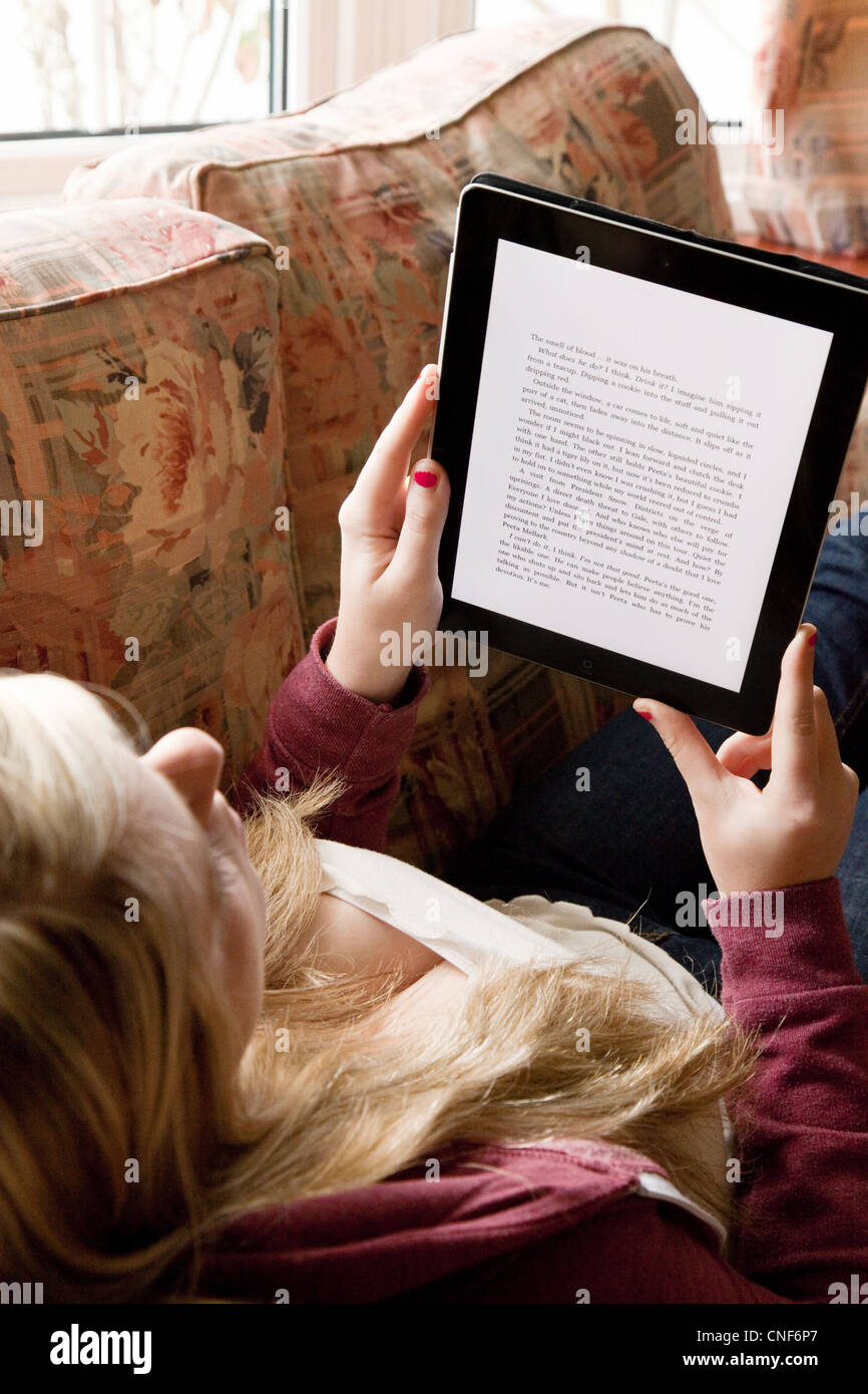 Teen Girl Reading An E Book On An Ipad Uk Teen Girl Reading An E Book On An Ipad Uk