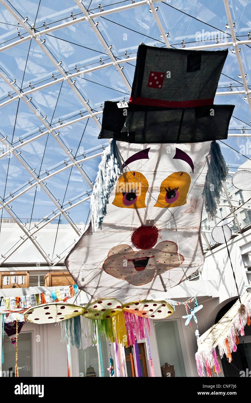 colorful humorous clown fantasy kite kites displayed under glass roof in courtyard of Museo de Arte Popular Mexico City Mexico Stock Photo