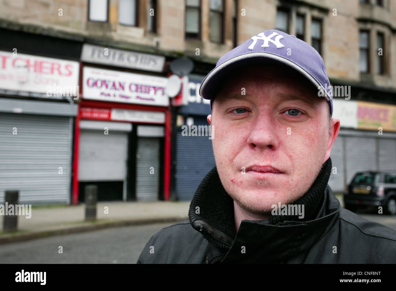 Young unemployed man in Shaw Street, Govan, Glasgow, Scotland Stock Photo