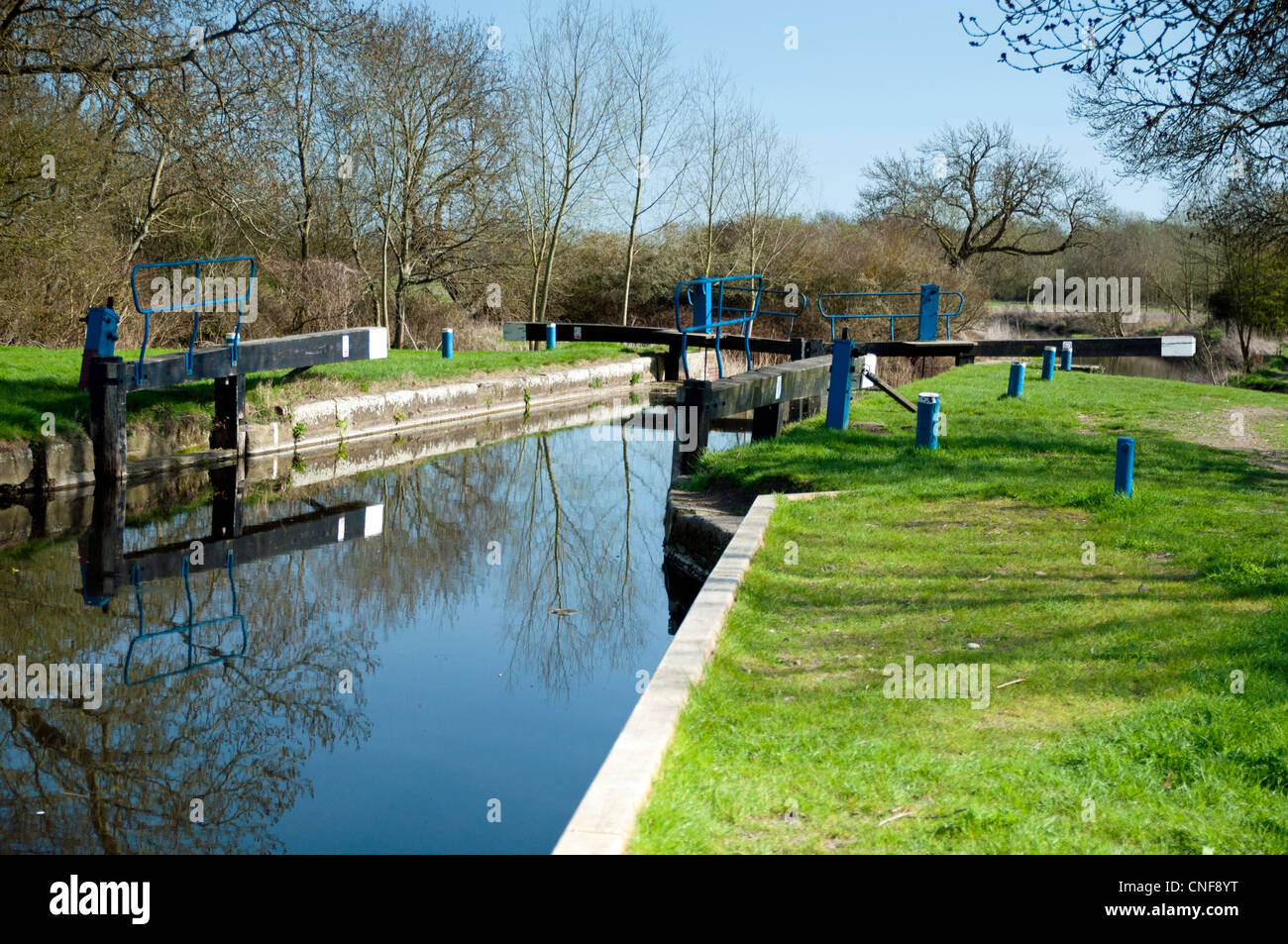 Open lock on river Chelmer with still water and reflection  of balance beam Stock Photo