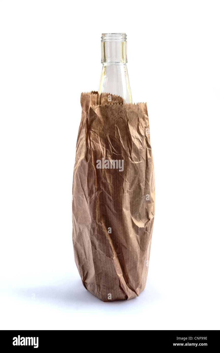 A bottle of alcohol in a brown paper bag isolated on a white background