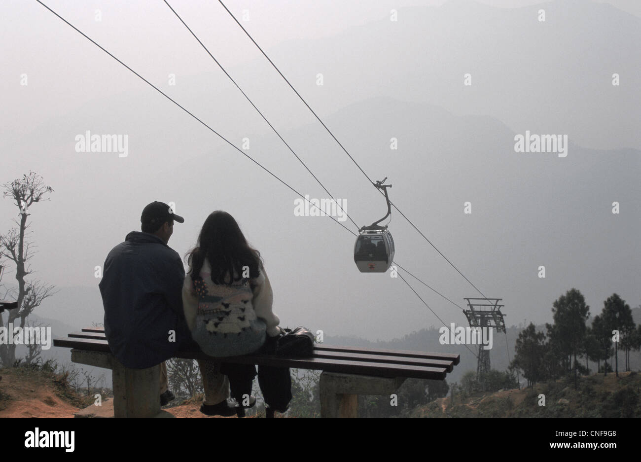 A couple is looking a cable car, the only one in the country ( Nepal) Stock Photo