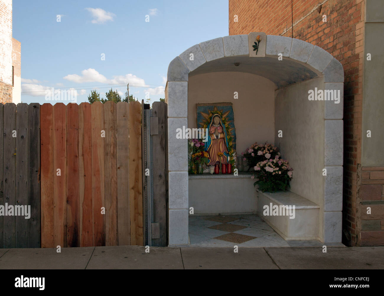 This shrine to Our Lady of Guadalupe is built on a city street by a private worshipper, yet open to the public. Stock Photo