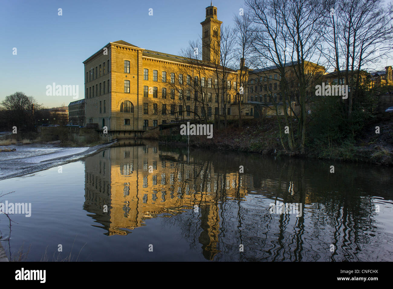 Salt's Mill reflected in the River Aire Saltaire West Yorkshire England Stock Photo