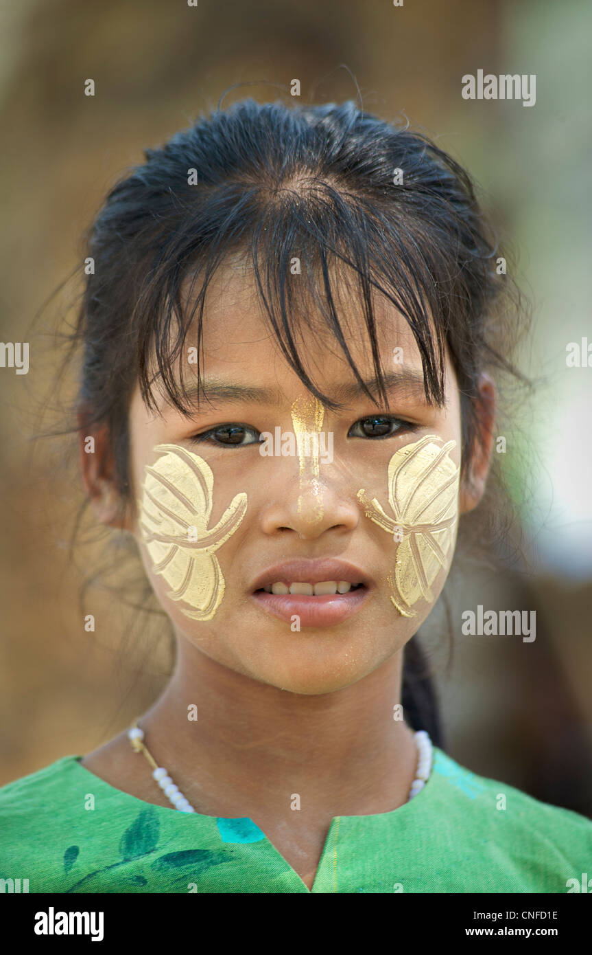 Portrait of a Burmese girl with tanaka, distinctly Burmese face decoration, Mandalay, Burma. Myanmar Stock Photo