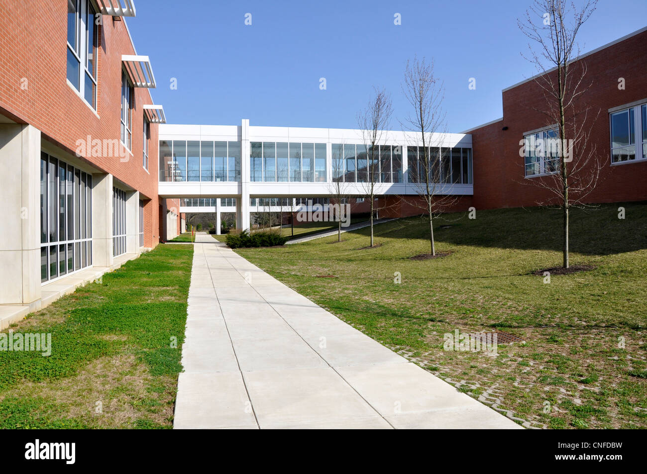 enclosed crosswalks connecting two red brick school buildings Stock Photo