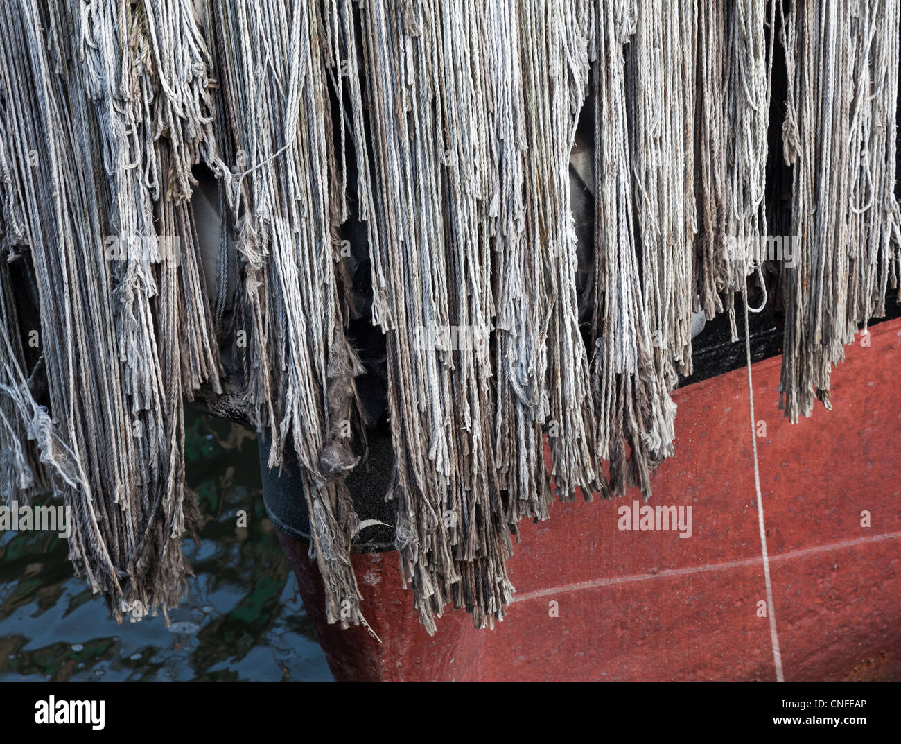Detail of a rope fender on prow of boat to protect against collision Stock Photo