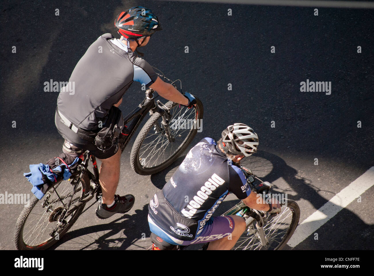 Two walking cyclists hi-res stock photography and images - Alamy