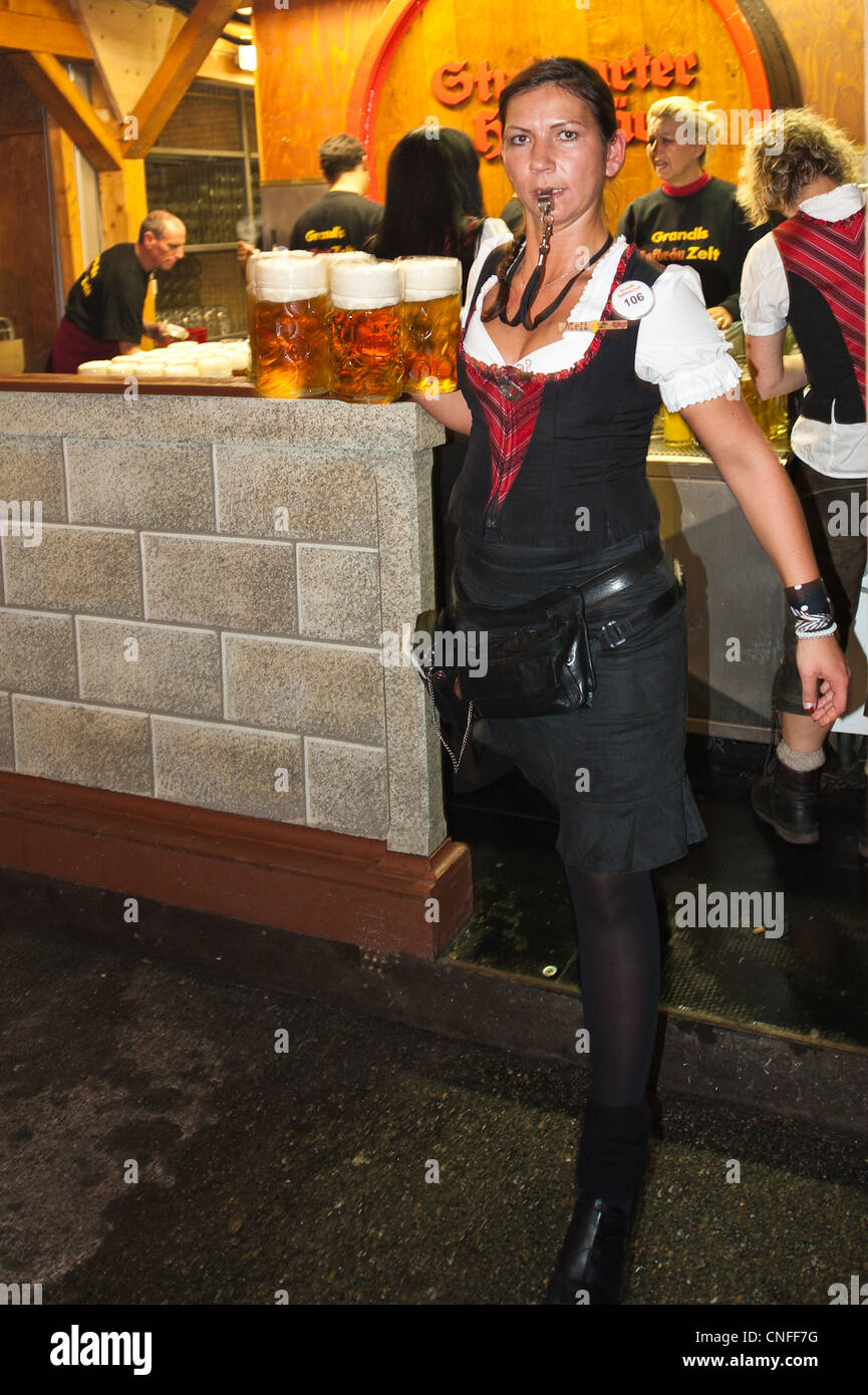 Woman Woman maid maiden carrying beer glasses at the Stuttgart Beer Festival, Cannstatter Wasen, Stuttgart, Germany. Stock Photo