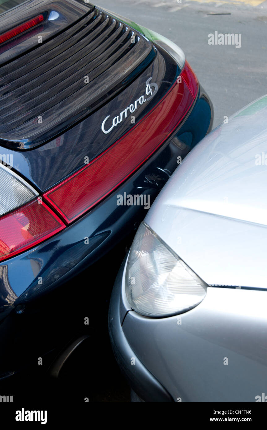 Tight parking with two cars parked with bumpers touching in Paris