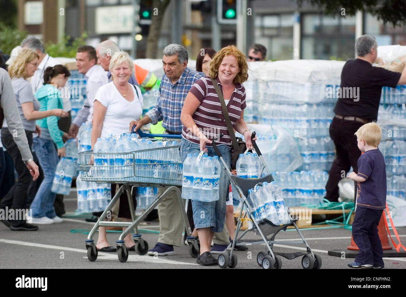 Flood victims - residents of Gloucester collect emergency supplies of bottled water from the carpark of the main Tesco. Stock Photo