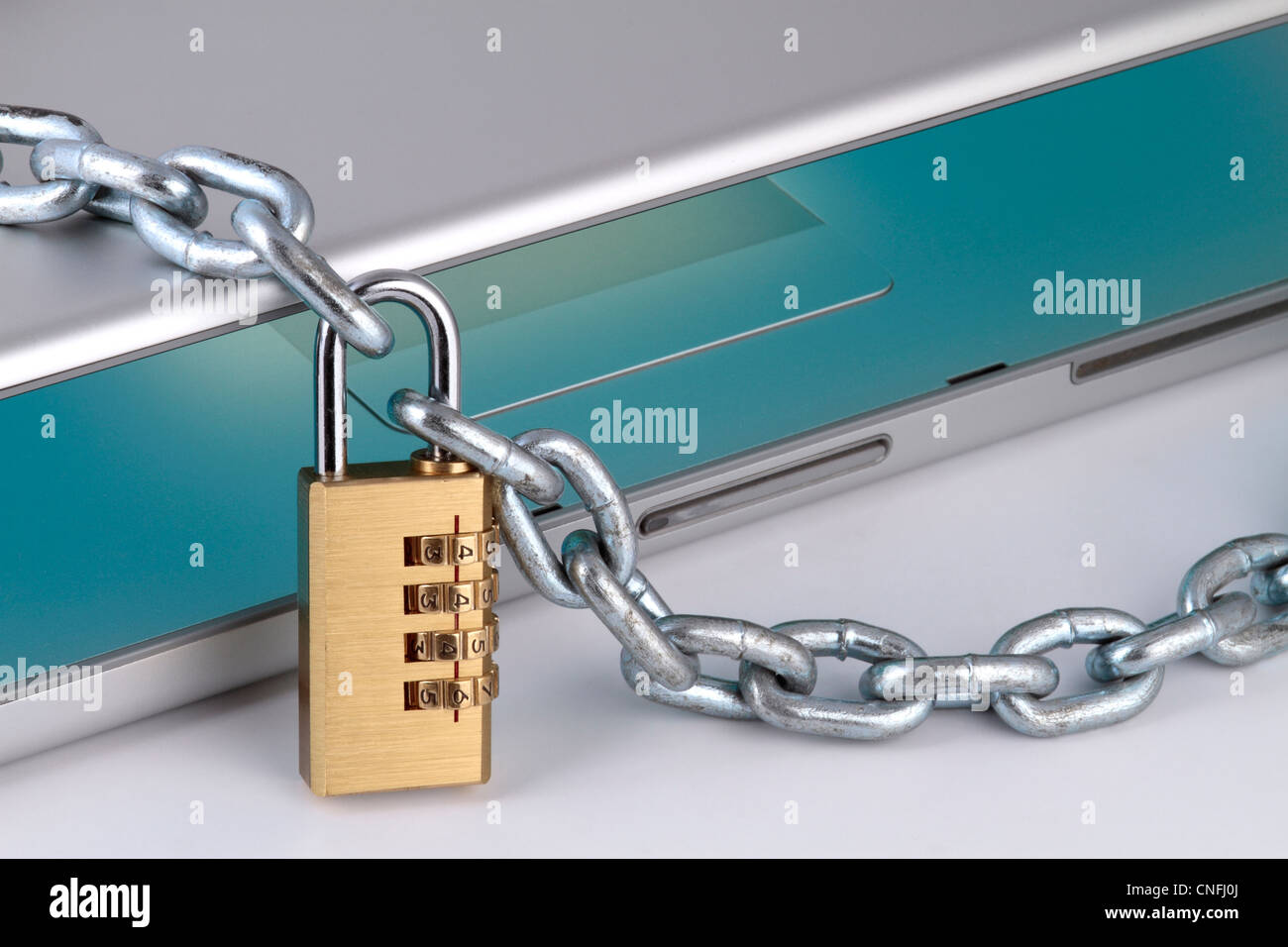 notebook with chain and digital padlock, symbolizing internet security, close up fragment. Stock Photo