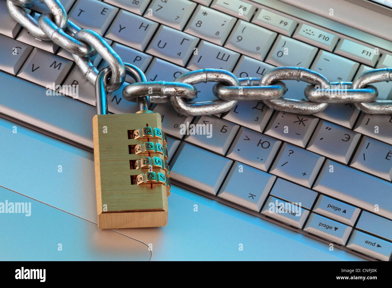 chain and digital padlock on computer keyboard, symbolizing internet security, close up fragment. Stock Photo