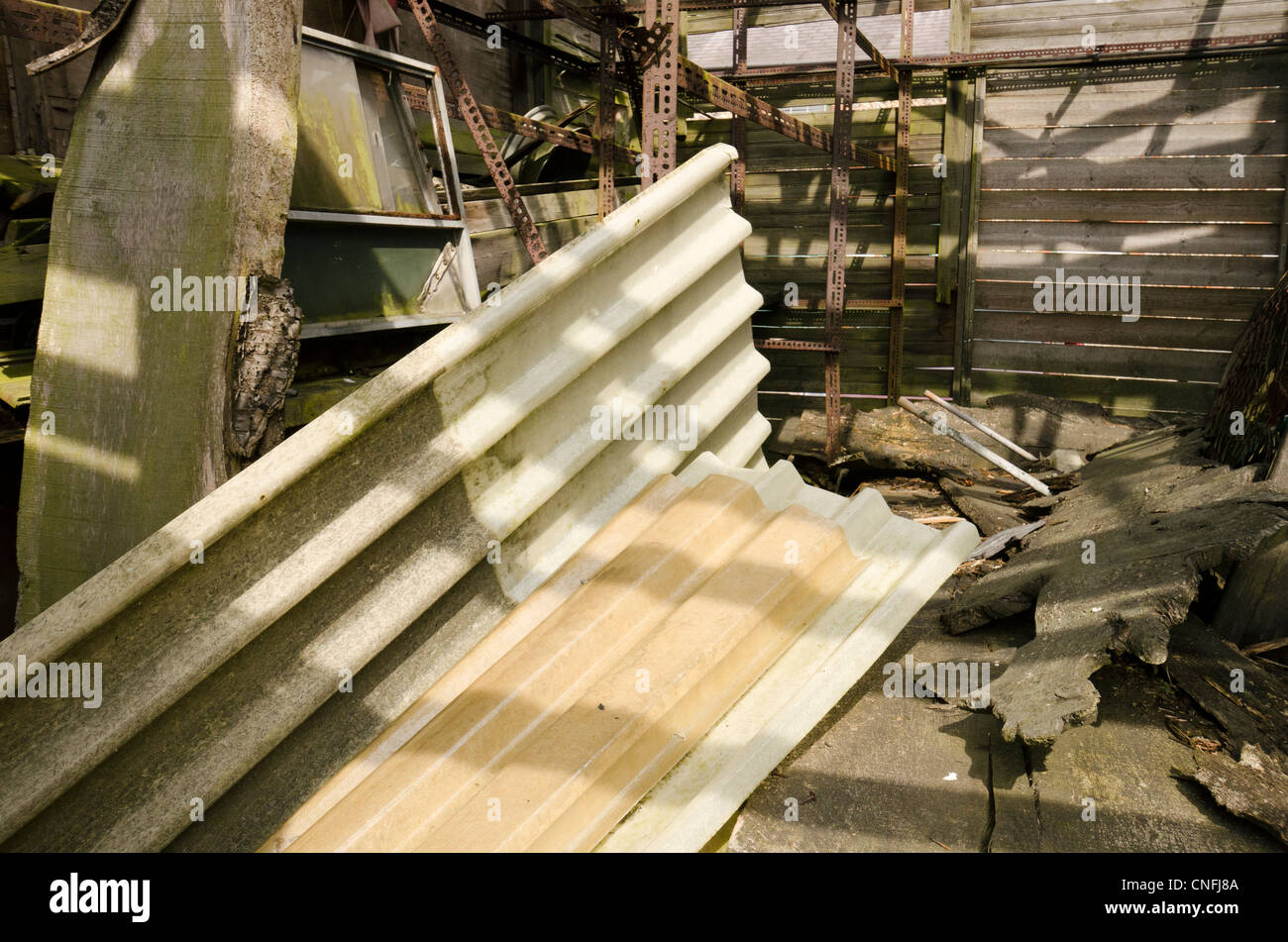 A pile of  discarded corrugated plastic, asbestos, debris and assorted filth and rubbish Stock Photo