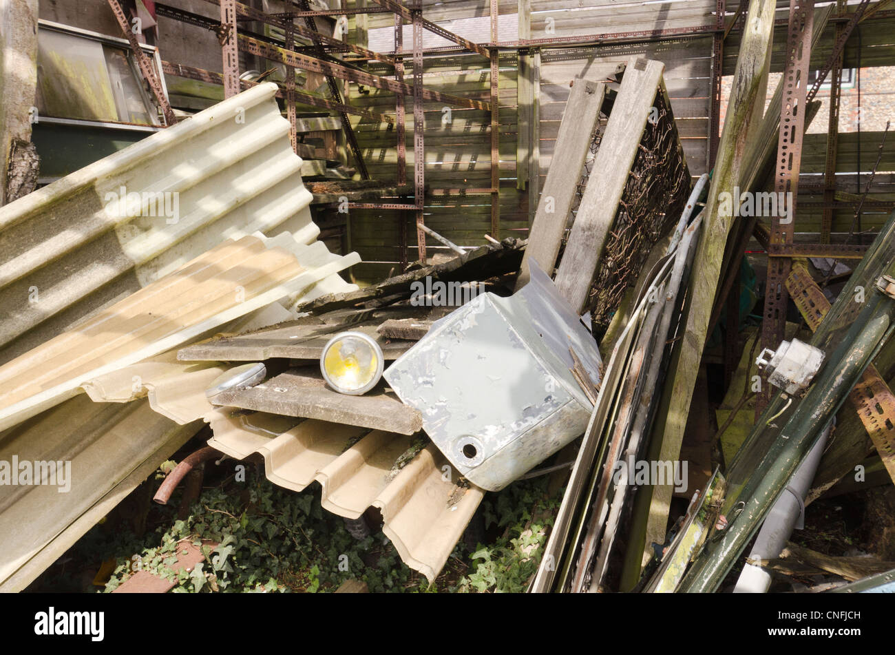 A pile of  discarded corrugated plastic, asbestos, debris and assorted filth and rubbish Stock Photo
