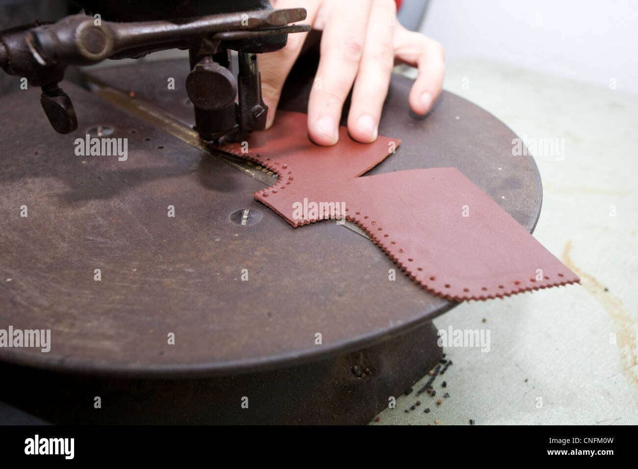 Shoe maker working on a piece of leather. Stock Photo