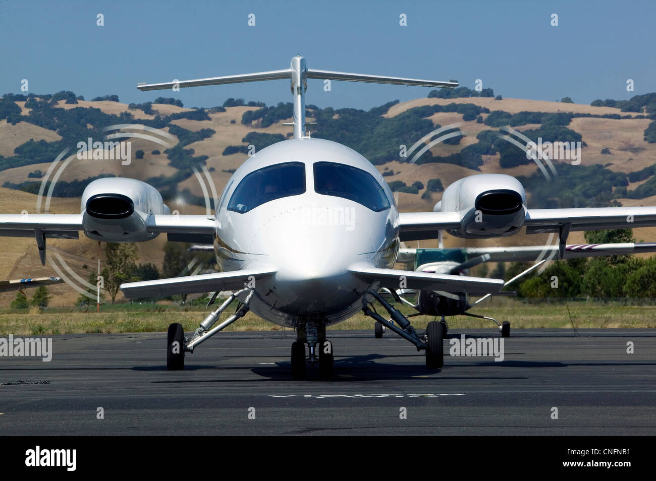 Piaggio aircraft spinning propellers preparing for takeoff at Petaluma airport, Sonoma County California Stock Photo