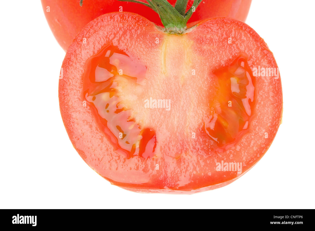 Fresh slice of red tomato isolated on a white background - shallow depth of field Stock Photo