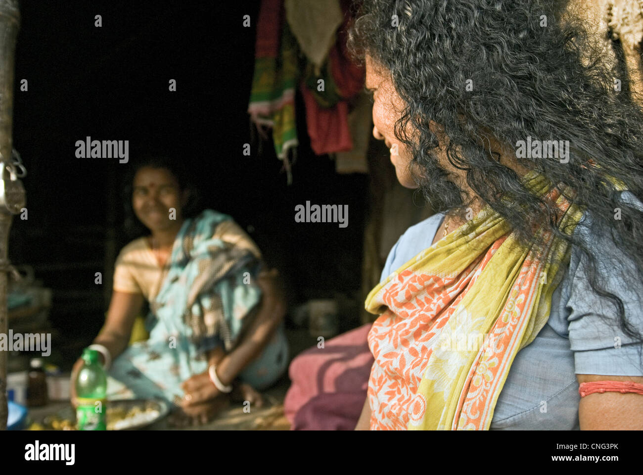 Women share smile in Kolkata slums, India Stock Photo