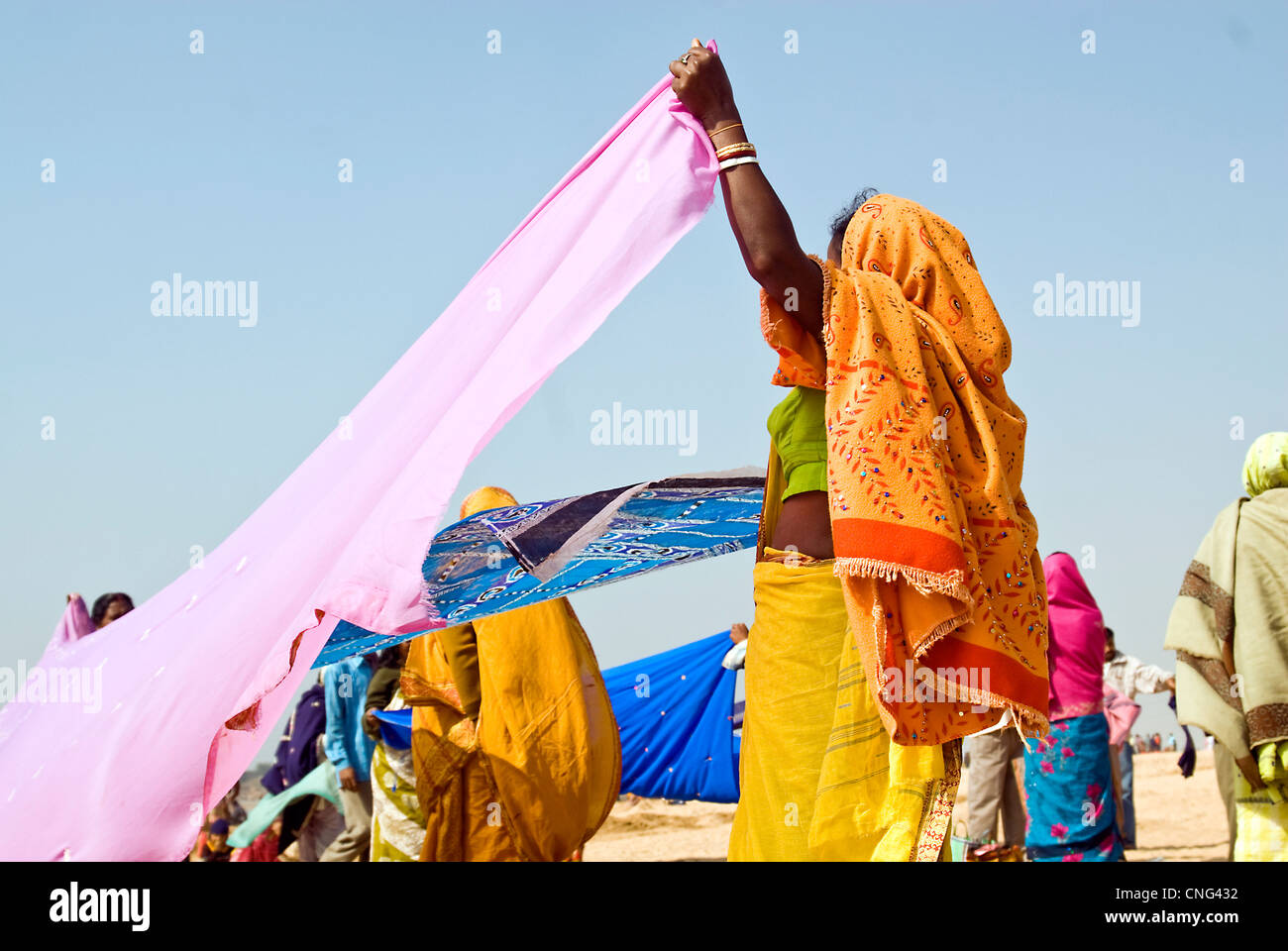 Woman drying her sari after bath during Keduli mela(festival) in Keduli ,West Bengal ,India Stock Photo