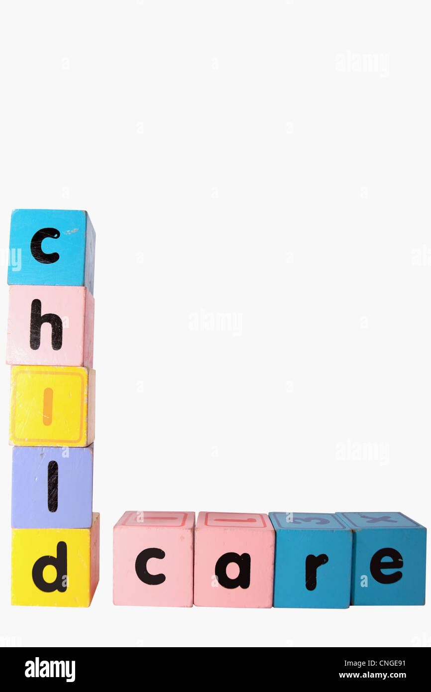 assorted childrens toy letter building blocks against a white background that spell childcare with clipping path Stock Photo
