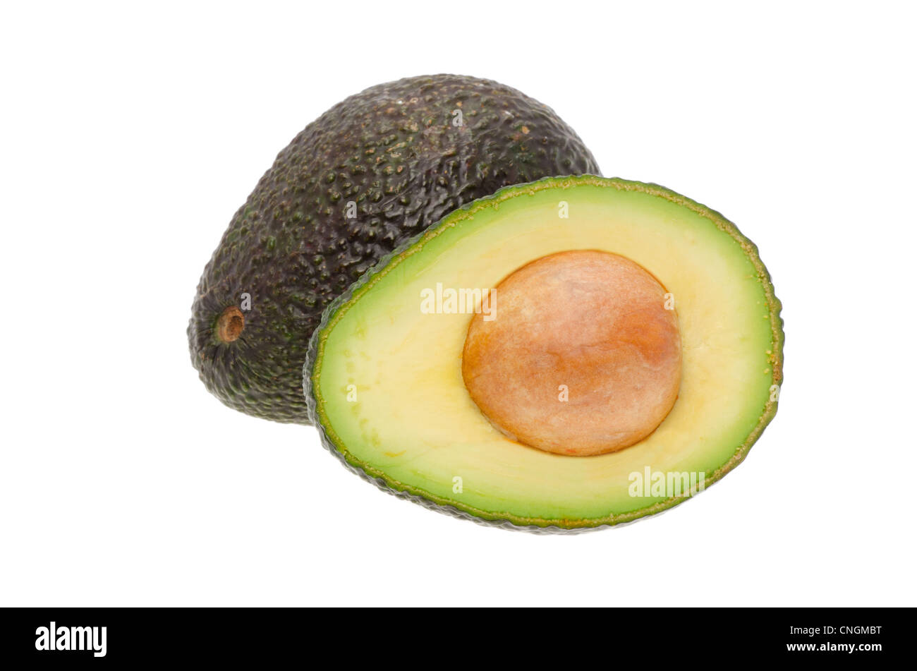 A whole avocado and another cut in half - shot in the studio with a white background Stock Photo