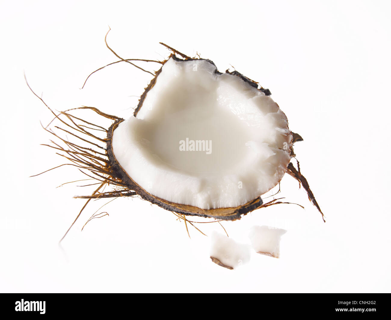 fresh raw coconut piece with husk and 2 pieces Stock Photo
