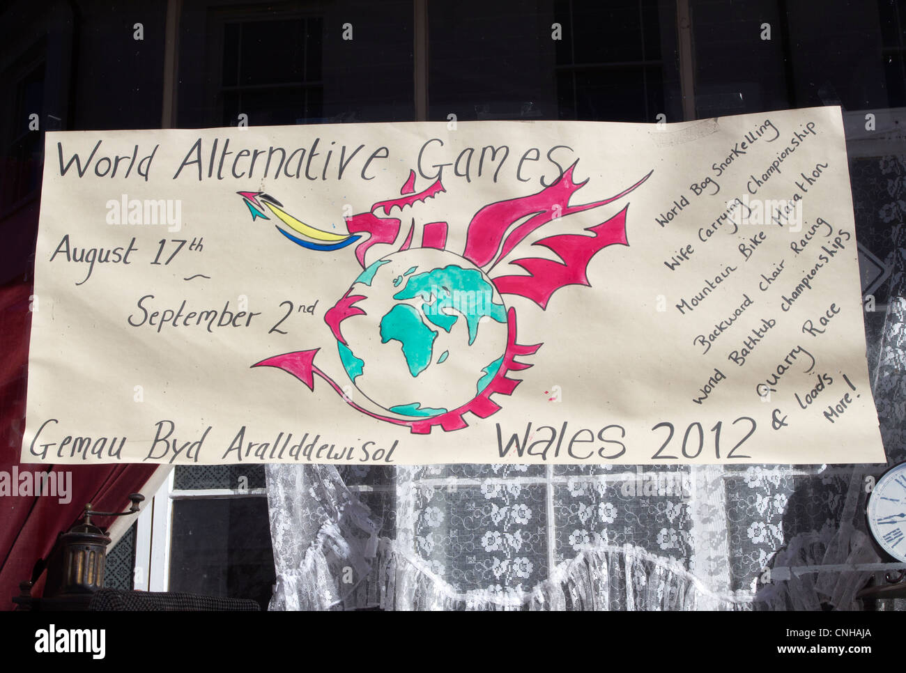 World Alternative Games poster in a shop window in Llanwrtyd Wells, Powys UK. Stock Photo